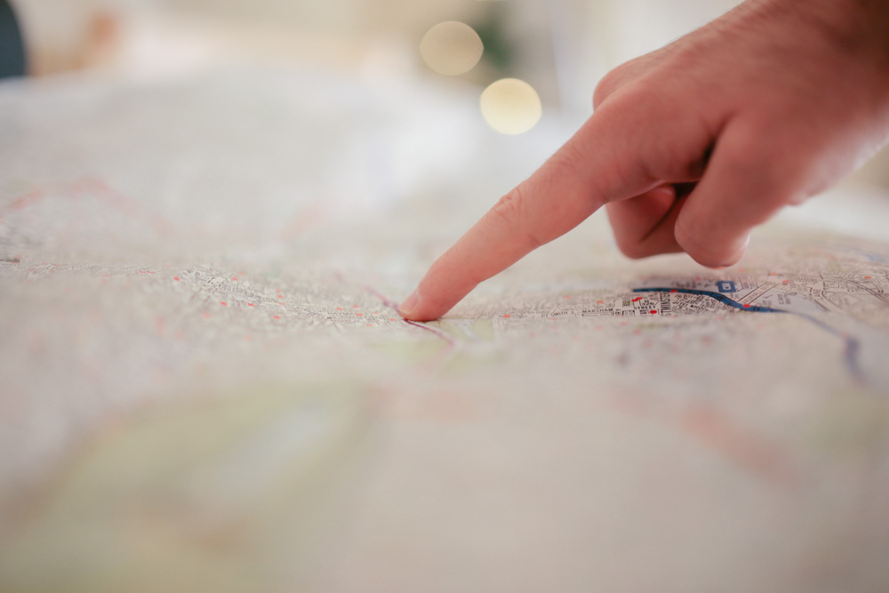Finger pointing to a map