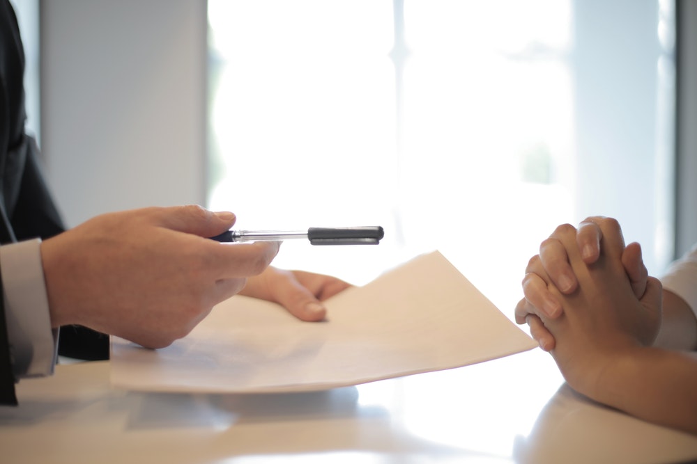 Handing over a paper and a pen