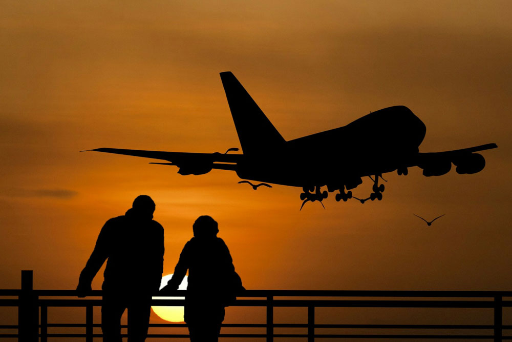 Plane flying during a sunset