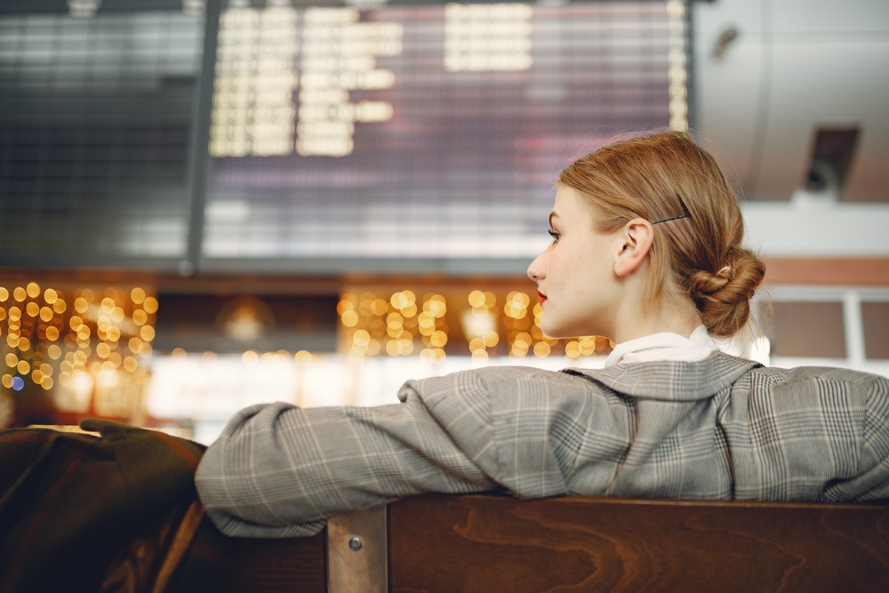 Young woman waiting for a flight at the airport