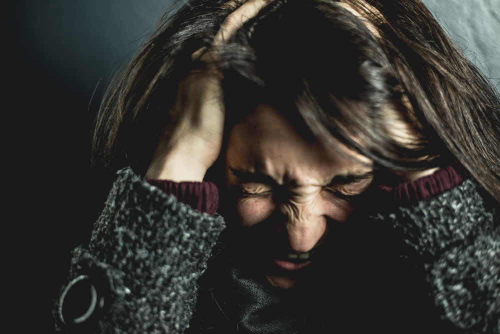 Woman holding her head