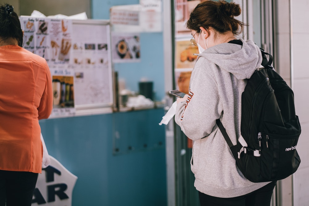 Young woman waiting in a queue