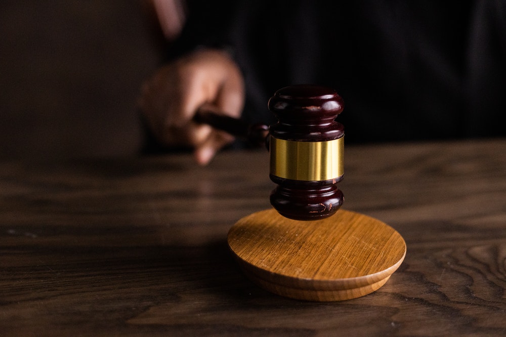 Brown wooden gavel on a table